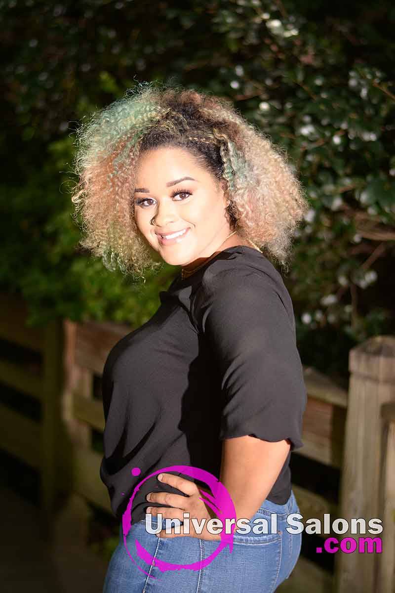 Model Standing Wearing a Natural Braid Out Hairstyle with Vivid Hair Color