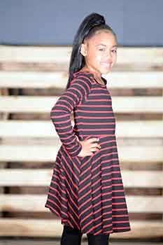 Model Standing: Sleek Straight Ponytail Black Hairstyles for Little Girls