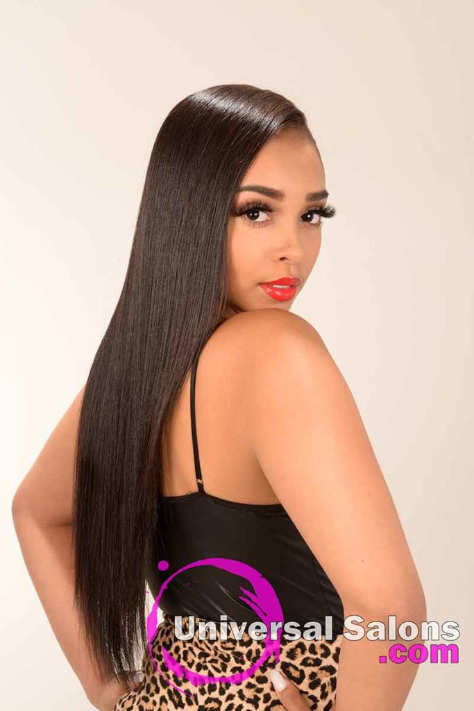 Model Looking Over the Shoulder With Long Silk Press Hairstyle
