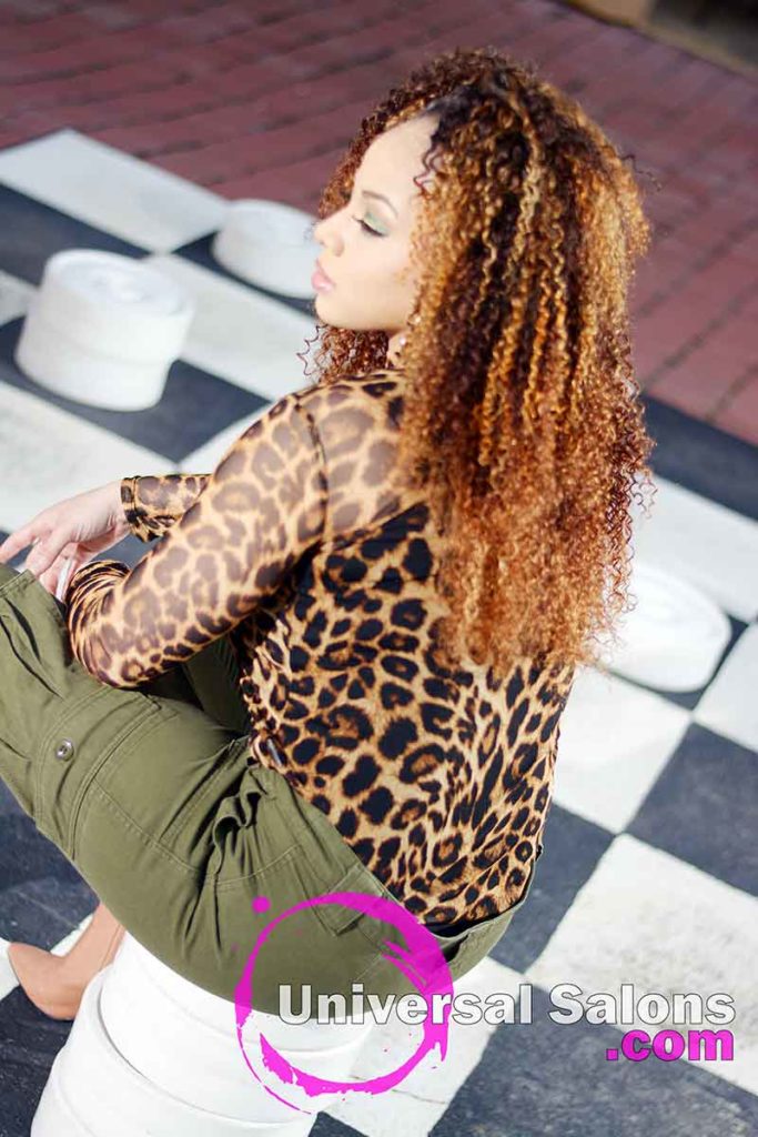 Model Sitting With Bohemian Curls Sew-In Hairstyle