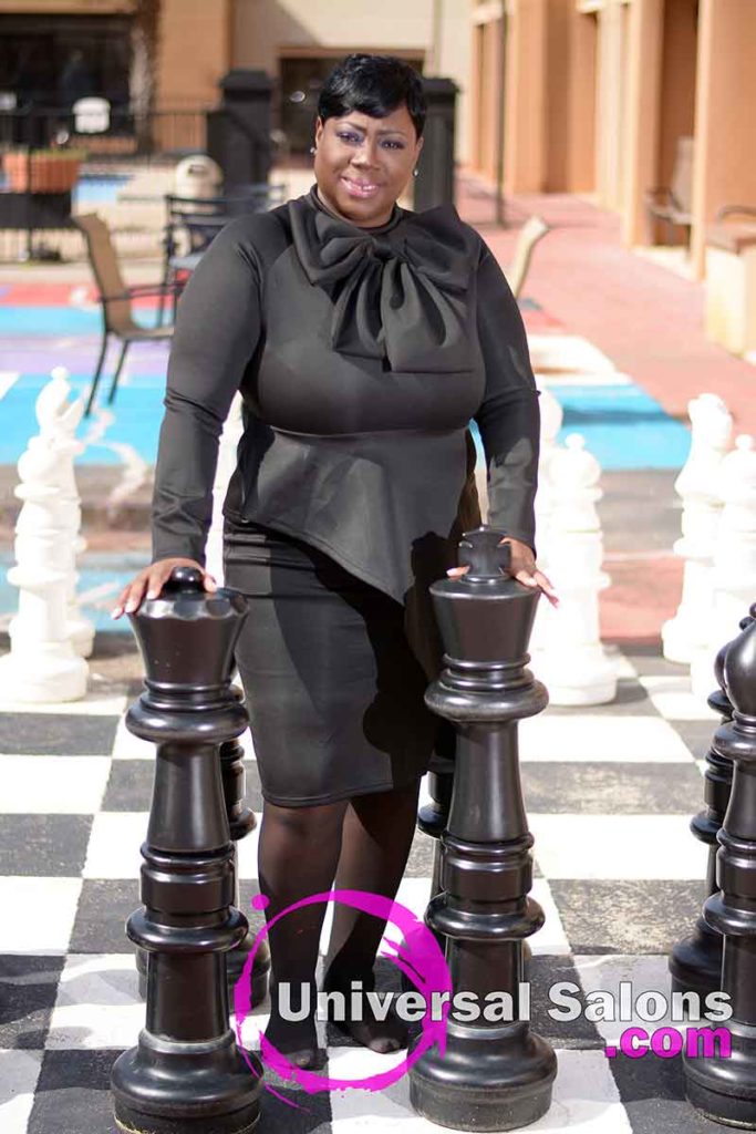 Model Standing Behind Chess Pieces With Short Quick Weave